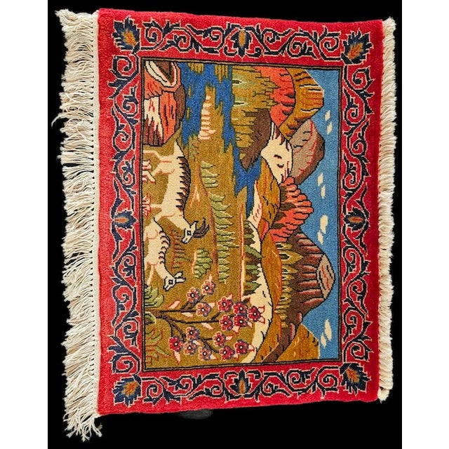 A graceful hand-knotted figurative rug originating in Isfahan, featuring a vibrant landscape scene with mountains, a...