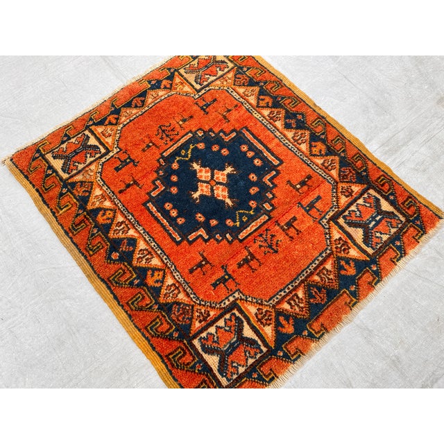 This antique hand-knotted Fachralo Kazak rug features a stepped octagonal medallion in navy with a cross motif at center,...
