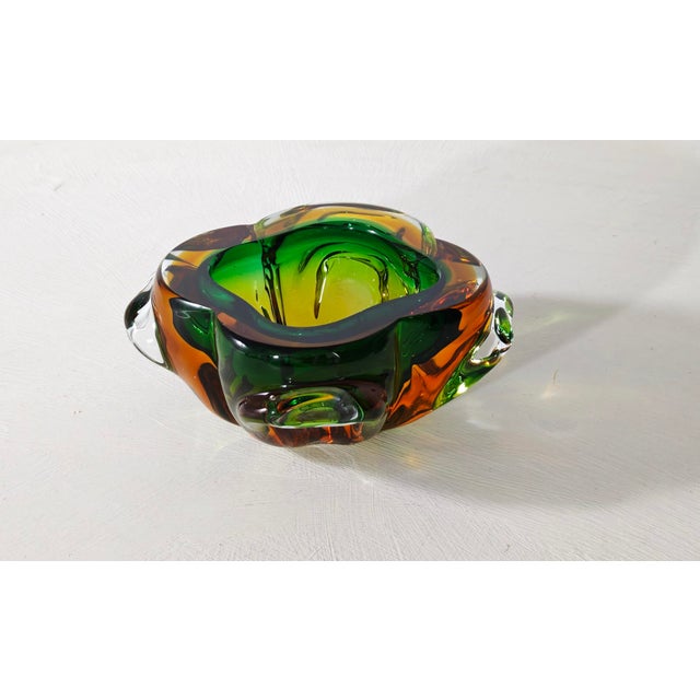 A stunning lobed Murano glass emptier bowl crafted using the renowned sommerso glass technique. The interior colors...