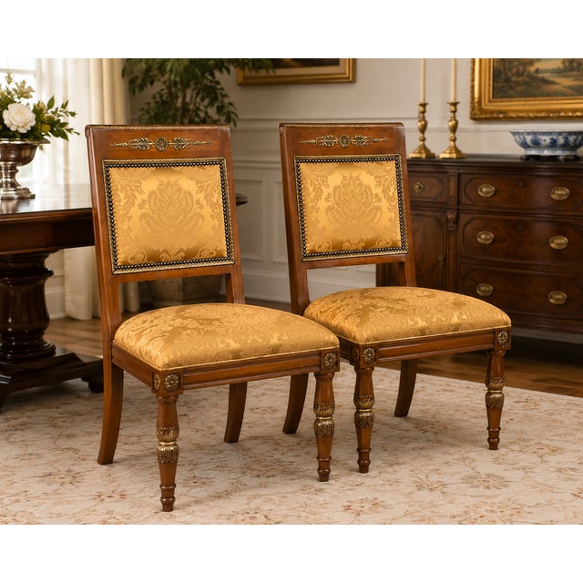 An elegant pair of Henredon “Grand Provenance” dining side chairs showcasing refined neoclassical styling with exceptional...