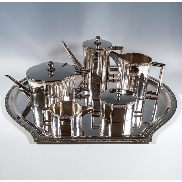 Elegant art nouveau silver service comprising six pieces: a coffee pot, a teapot, a cocoa or hot water pot, a cream jug, a...
