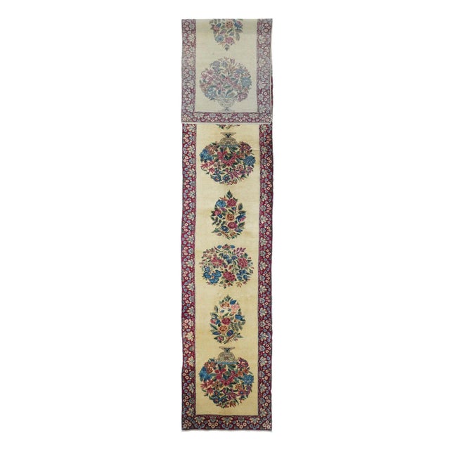 This attractive SE Persian narrow city Kenare (runner) features a straw-ecru field with flowering vases, and round and...