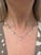 This classic necklace by Jose Hess contains five platinum half bezeled round brilliant cut diamond stations weighing...