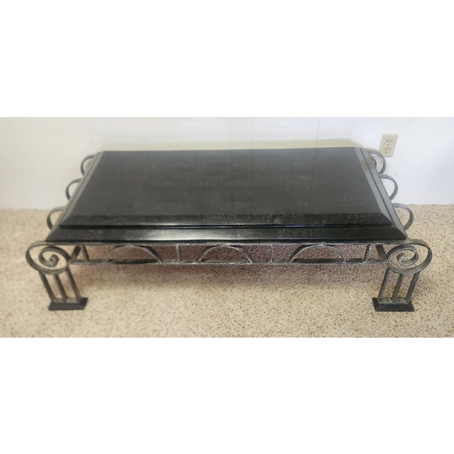 dramatic coffee table inspired by the stunning French Art Deco of the 1920s, scrolled iron with two layered black marble...