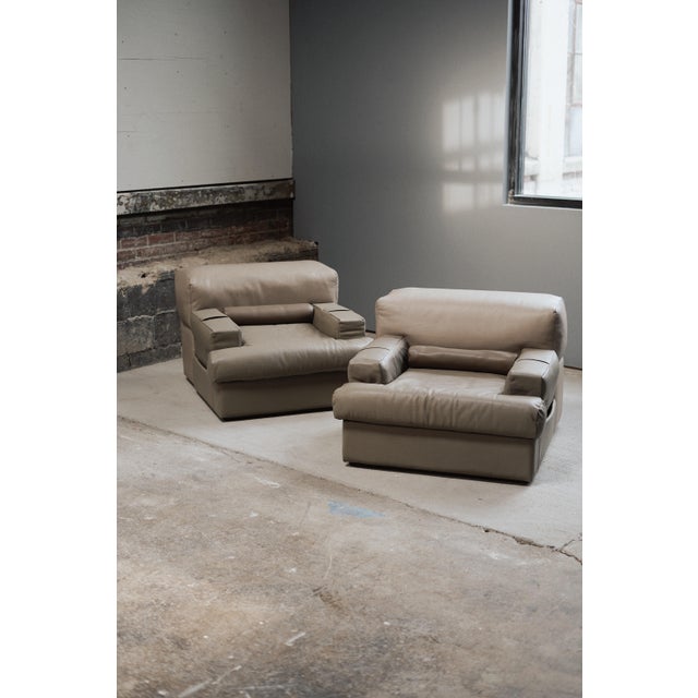 Pair of Percival Lafer MP-141 chairs crafted in the 1970s. Each chair features retractable arms to create a settee when...