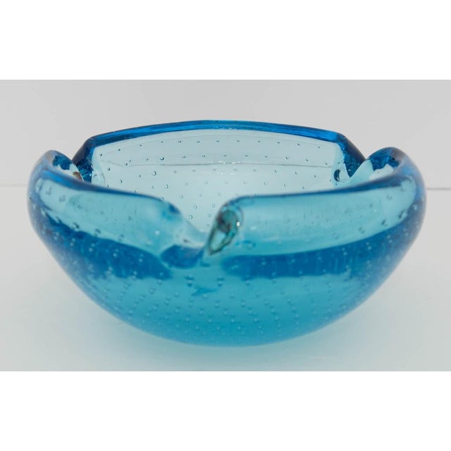 Heavy cased Murano ashtray in vivid turquoise blue with three rim notches, executed in the bullicante technique - a...
