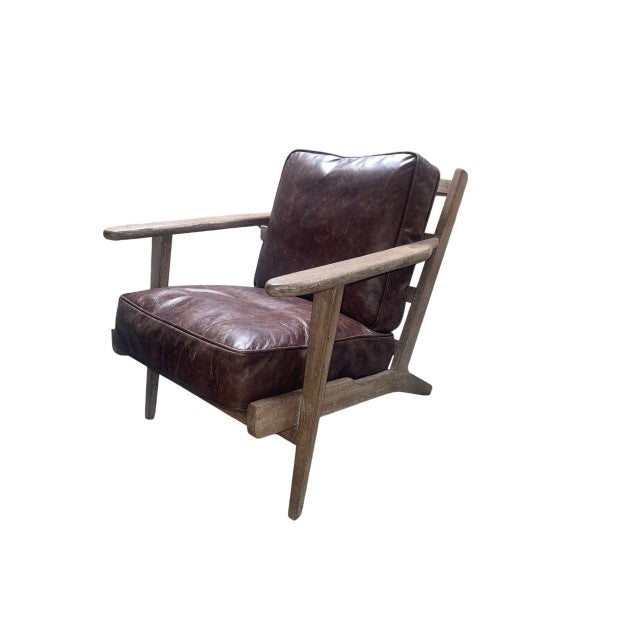 Handsome pair of Irondale Brooks lounge chairs by Four Hands, crafted in the United States in the 21st century. These...