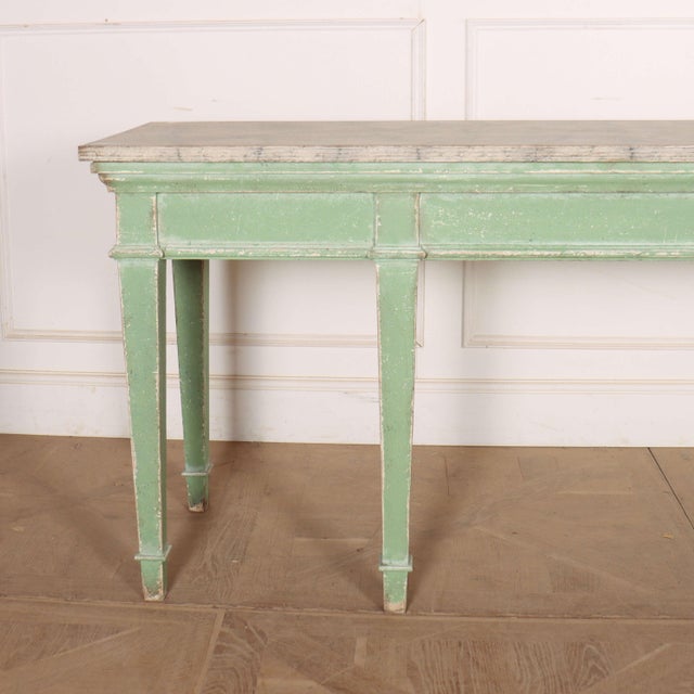 Wonderful 19th century English painted pine console table with a faux marble top. 1880. This piece is designed in the...