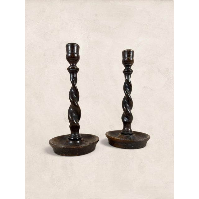 Barley twist candlesticks carry a quiet authority that few decorative objects can match. This hand-carved oak pair, with...