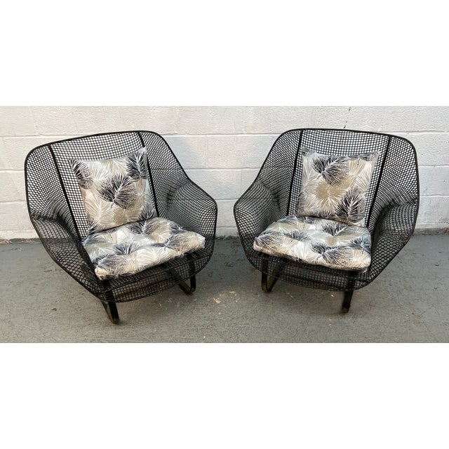 Vintage mid-century modern Woodard Sculptura lounge chairs featuring a distinct black expanded metal mesh shell on a...