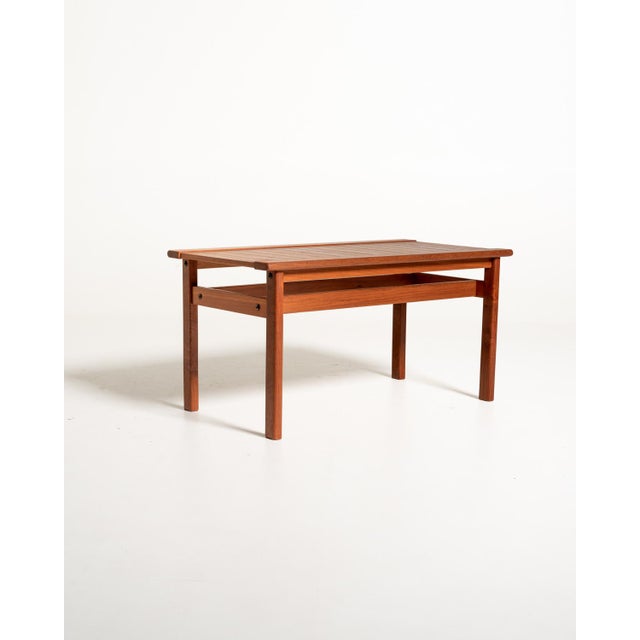Teak top made of slats, raised edges, and a four-legged structure with lateral crosspieces. Scandinavian production,...