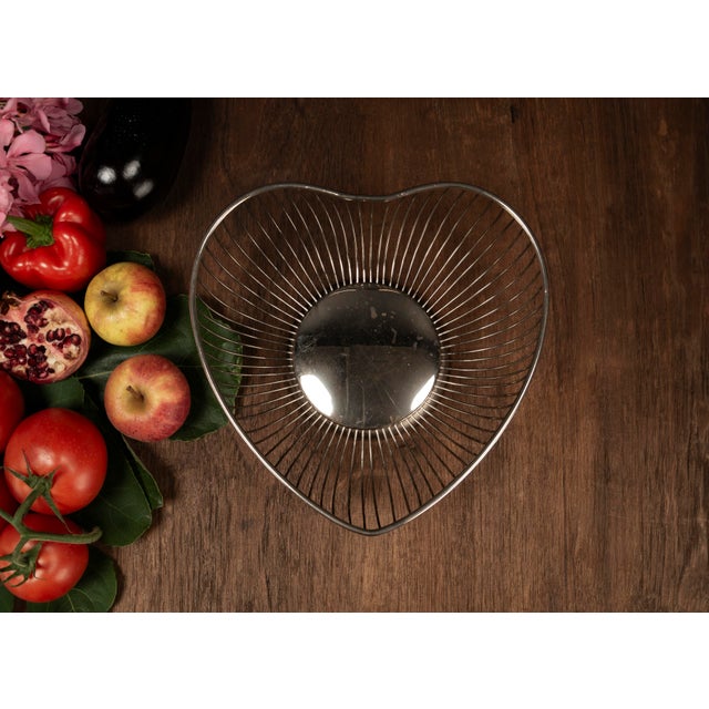 Sculptural, lightweight, and timeless, this Mid Century fruit basket made of curved metal wire combines functional design...