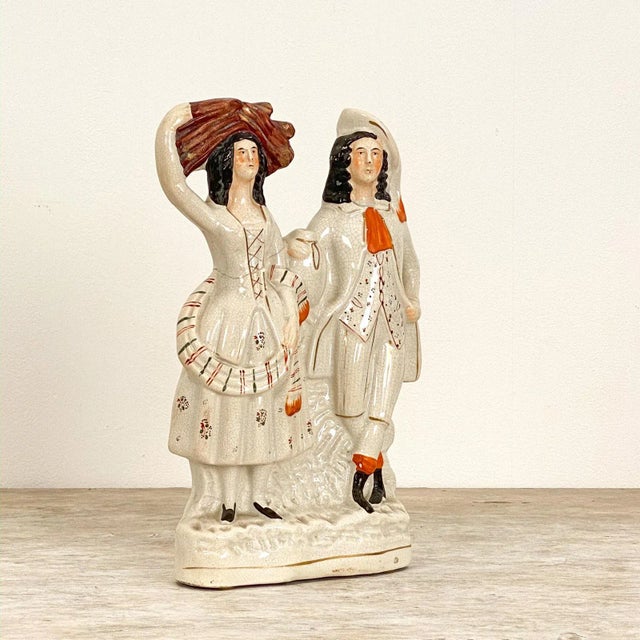 A large English Staffordshire of a man and a woman, circa 1880.