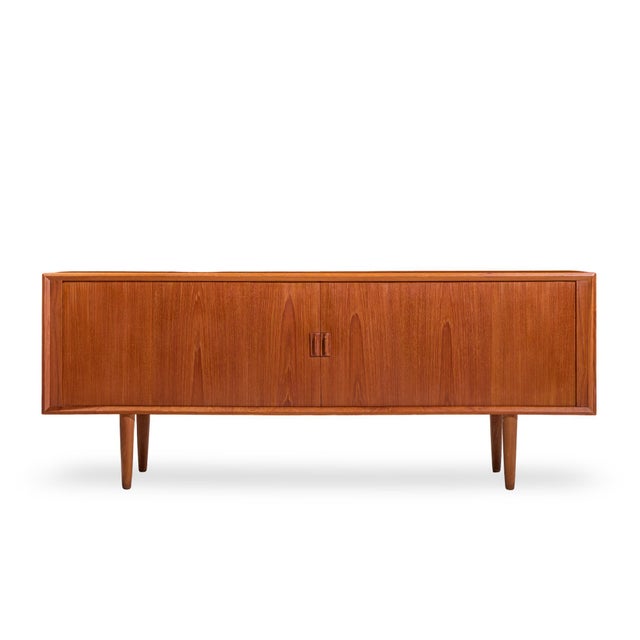 Svend Aage Larsen Mid Century Danish Teak Tambour Door Credenza This credenza measures: 80 wide x 19 deep x 31.5 inches...