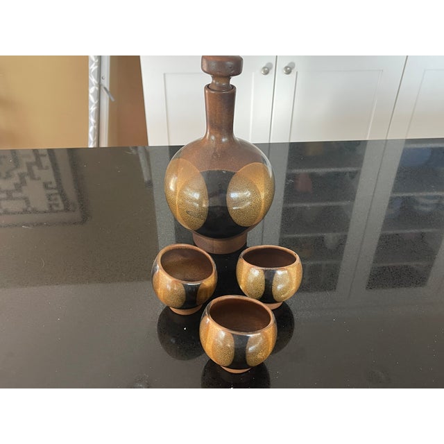Beautiful California pottery craft by Robert Maxwell (USA 1960s-1970s) consisting of a bulbous ceramic decanter and three...