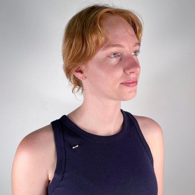 A fine Edwardian stick pin. In 14k gold. Prong-set with an off-round, Old European cut white diamond that is flanked on...