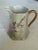 This vintage Hutschenreuther Selb porcelain creamer features hand-painted floral motifs, 22-24K gold gilding, and a...