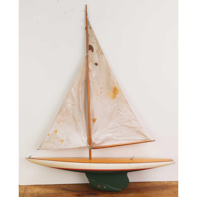 Charming small pond yacht Original paint and sails No stand There are some condition issues to both sails and hull. These...