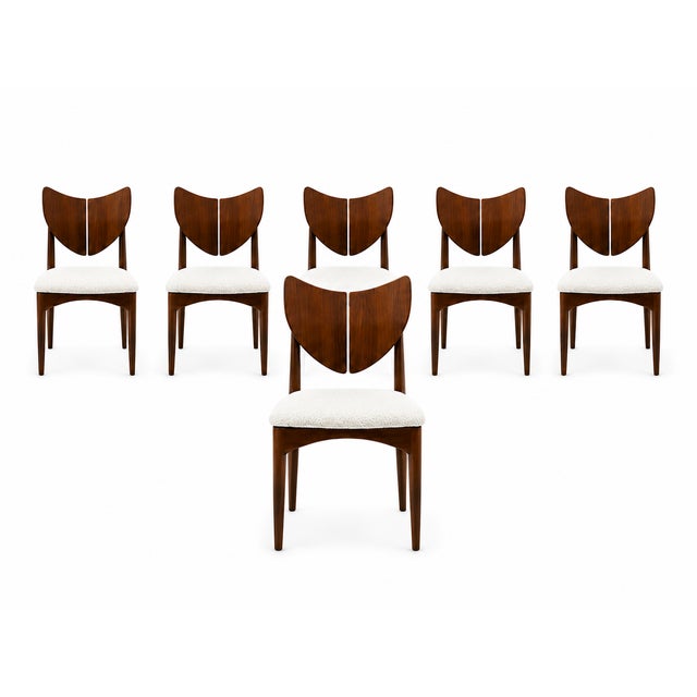 Mid century style solid walnut dining chairs. The chairs are is the style of Kurt Ostervig butterfly iconic butterfly...