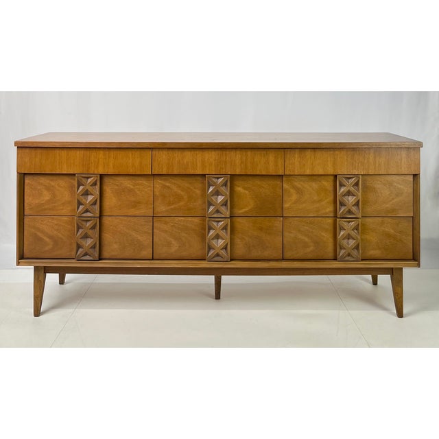 Striking Mid-Century Modern triple dresser credenza from the Zenith line by Bassett Furniture Industries. Crafted in warm,...