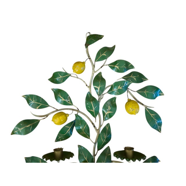 A vintage, Italian tole candle sconce. Features an iron, tole form potted, lemon tree with a double arm candle sconce....