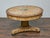 An Italian Neoclassical style faux marble painted center table from the 19th century with circular top and pedestal base....