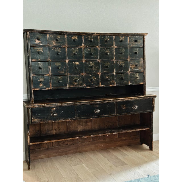An incredibly rare and stunning antique Hungarian apothecary shop counter consisting of an upper and lower portion. Please...