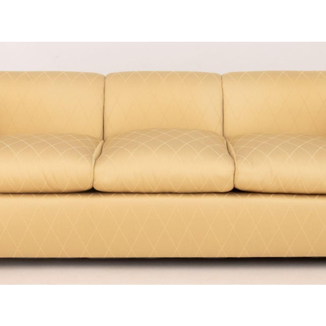 Modern Golden Silk Blend Upholstered Three-Seat Sofa, with scrolled ends. 28" H x 86" W x 36" D; seat: 18" H. Provenance:...
