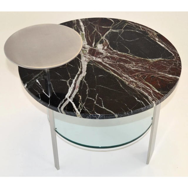 This stunning table is handcrafted using three kind of materials as satin-finished stainless steel for the three legs and...