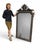 An exceptional Gothic Revival Victorian mirror, distinguished by its finely detailed black gesso frame enriched with...