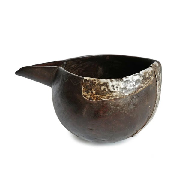 Vintage handmade village pitcher from North Africa. Rich dark wood with original aluminum repairs and traditional...