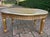 A refined 1950s French Louis XVI-style coffee table, beautifully crafted from solid beech wood with a woven cane top and a...