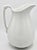 A lovely, large ironstone white pitcher. Perfect farmhouse decor! It works as a pitcher or a vase. Beautiful design on the...