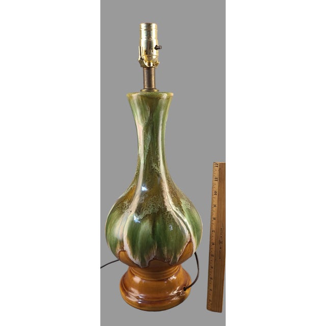 This Mid-Century Modern table lamp is a beautiful addition to any room. The lamp features an olive green and camel brown...
