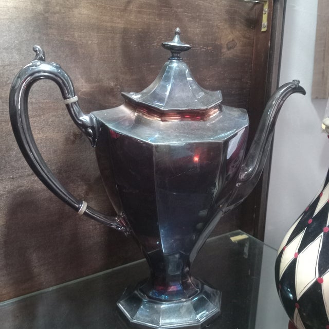 This elegant Reed & Barton silverplate coffee pot, pattern No. 3690, dates to the early 20th century and showcases a...