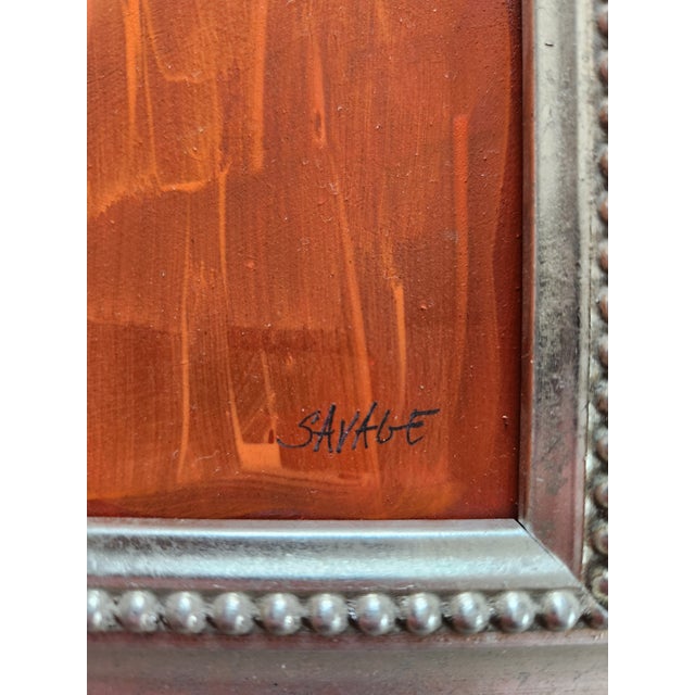 This painting depicts a abstract design of a person with an orange background and a silver frame. Shawn Savage, a noted...