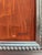 This painting depicts a abstract design of a person with an orange background and a silver frame. Shawn Savage, a noted...