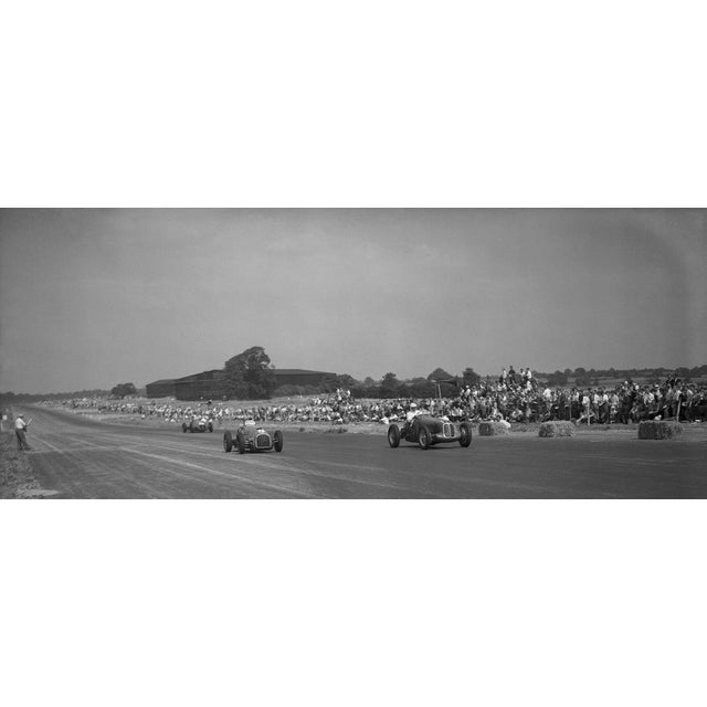 Ascari At Silverstone 25th August 1949: Italian motor racing driver Alberto Ascari (left) approaching Stowe Corner in a...