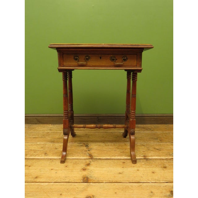 An attractive small work table dating to the early 20th Century. Made of mixed woods the table features a decorative...
