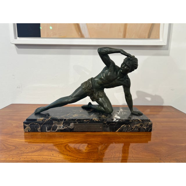 Elegant art deco sculpture of an athletic scouting / watching male figure by jean de roncourt from france around 1930....