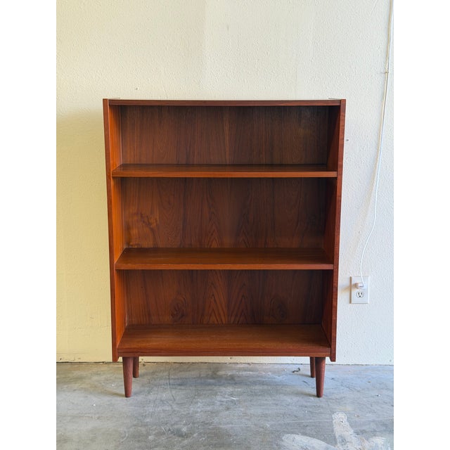 Mid-Century Modern Danish cabinet crafted in warm, richly grained teak. This versatile piece features an open shelving...