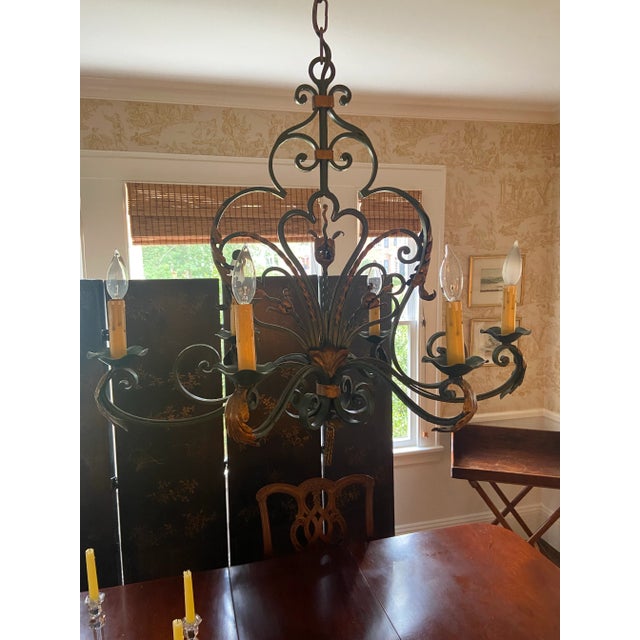 This rustic French wrought iron 6 arm chandelier is charming. It works in a dining room or breakfast room. It is hand...