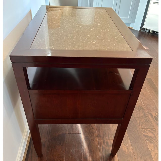 The Knowledge bedside table by Kindel features a brass pull hardware. The case is crafted of Cherry solids and straight-...