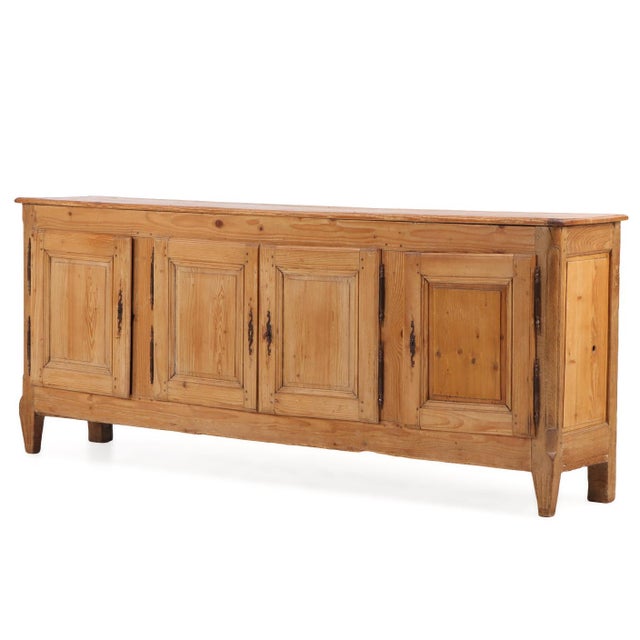 An unusual late nineteenth-century Belgian pine sideboard featuring contrasting oak end frames and a broad, architectural...