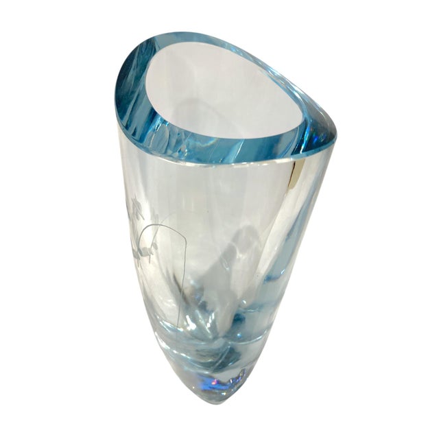 This is a charming mid-century Swedish crystal vase produced by Strömbergshyttan featuring a finely engraved fisherman...