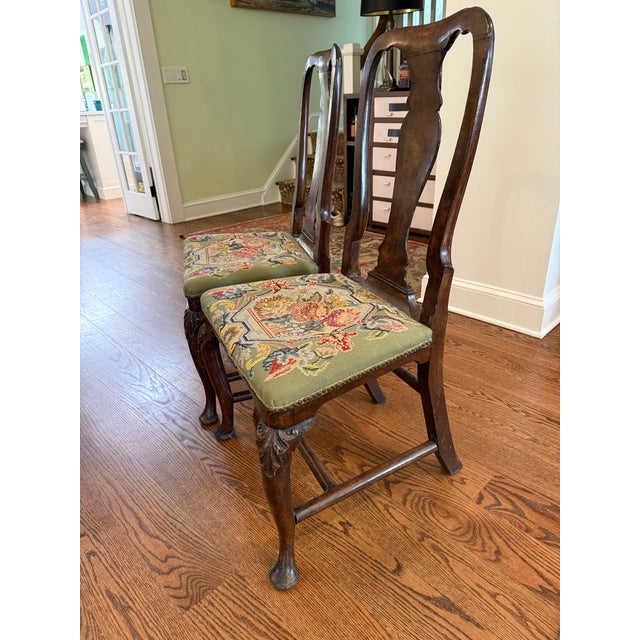 A stunning pair of Queen Anne side chairs that marry exceptional craftsmanship with extraordinary needlepoint artistry....