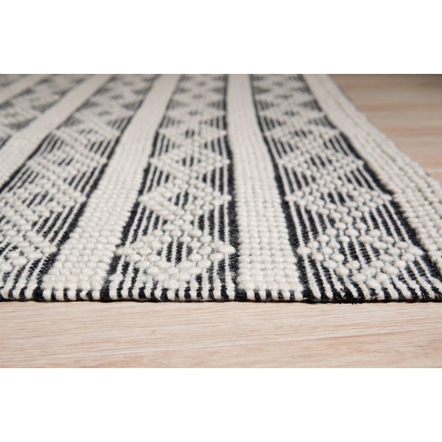 Selene Striped Black Handmade Wool Rug, Country of Origin: India. This striking flatweave is a contemporary interpretation...