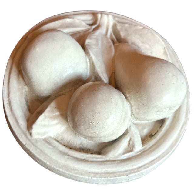 Hand-cast plaster wall plaque featuring a sculptural fruit-and-leaf relief in the neoclassical tradition. The...