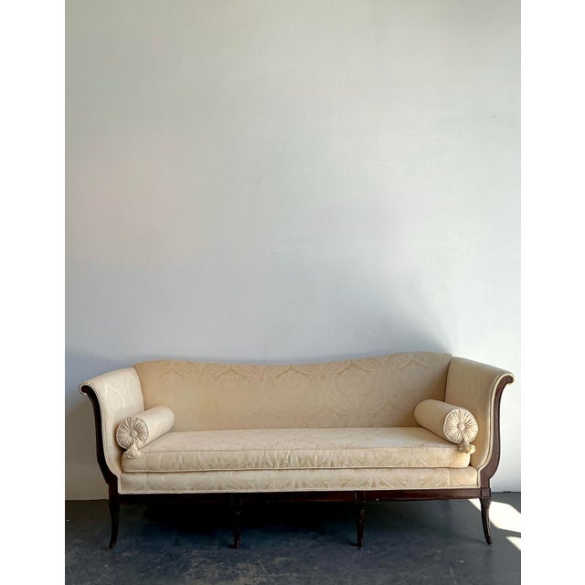 This elegant vintage Federal-style sofa is a masterclass in Neoclassical restraint and traditional craftsmanship. The...