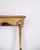 Wall mounted console table made in gilded wood with carvings in Rococo style from around the 1920s. The console table...